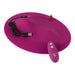 Purple oval-shaped Vibepad with USB charging cable, remote control, and battery on a white background.