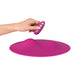 Ergonomic magenta silicone VibePad with remote control held by hand, designed for targeted external stimulation.
