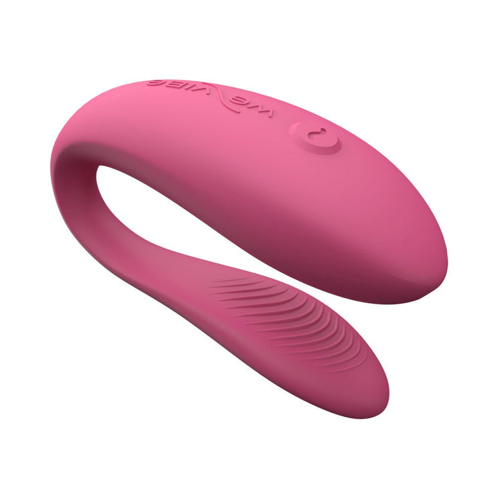 Pink silicone We-Vibe Sync Lite couples vibrator with ergonomic curved design and single-button control.