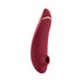 Womanizer Premium 2 clitoral stimulator in deep red with gold accent, featuring a silicone body and air pulse technology.
