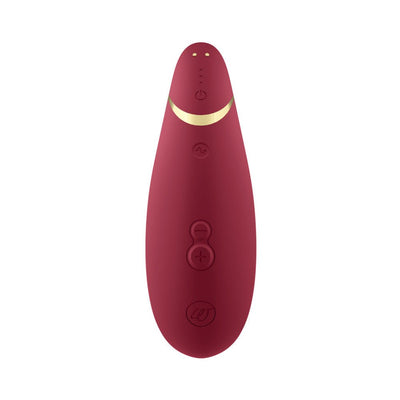 Womanizer Premium 2 clitoral stimulator in deep red with gold accent and multiple control buttons on a white background.