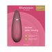 Womanizer Premium 2 clitoral stimulator in raspberry color displayed on pink packaging with product features and branding.