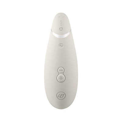 Womanizer Premium 2 clitoral stimulator in soft beige with ergonomic design and control buttons on front.