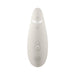 Womanizer Premium 2 clitoral stimulator in soft beige with ergonomic design and control buttons on front.
