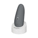 Gray Womanizer Starlet 3 clitoral stimulator with control buttons on white charging stand.
