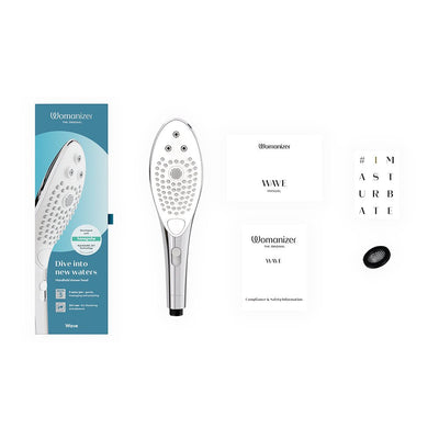 Womanizer Wave Shower Head Masturbator with packaging, user manual, safety information, and small accessory on white background.