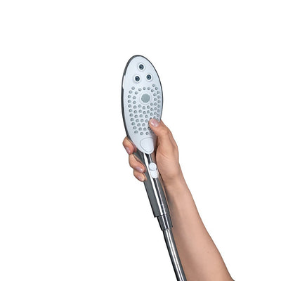 Hand holding the sleek Womanizer Wave shower head with multiple jet nozzles and ergonomic design against a white background.