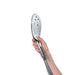 Hand holding the sleek chrome Womanizer Wave Shower Head Masturbator with silicone nozzles and control button.