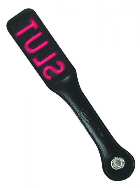 12-inch black leather paddle with pink cutout letters spelling "SLUT" and stitched handle with metal grommet.