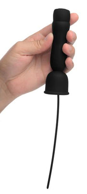 Hand holding a black silicone penis head teaser with flexible urethral sound and attached power cord.