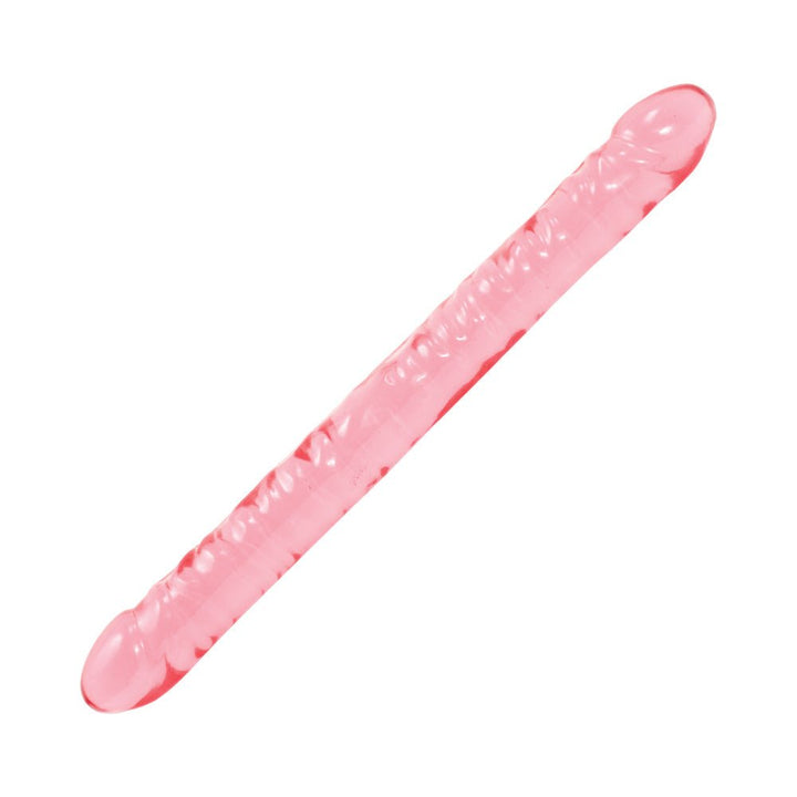 Pink translucent double-ended flexible silicone toy with textured surface and rounded ends.