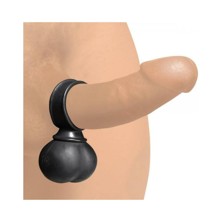 Black vibrating balls cock ring worn on a realistic silicone penis model.
