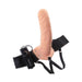 Adjustable flesh-colored vibrating hollow strap-on with black elastic harness and remote control on white background.
