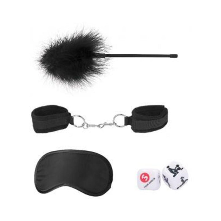Black introductory bondage kit with feather tickler, adjustable velvet cuffs, satin blindfold, and playful dice on white background.