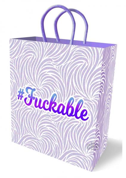 White and pastel purple patterned gift bag with purple woven handles and metallic #Fuckable text on front and sides.