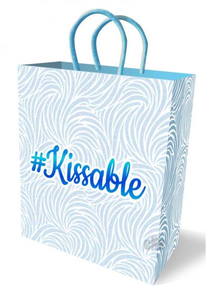 Pastel blue and white gift bag with swirling pattern and #Kissable logo, featuring sturdy woven handles.
