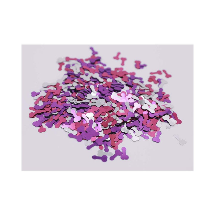 Pile of metallic confetti in red, purple, blue, and pink colors on a white background.