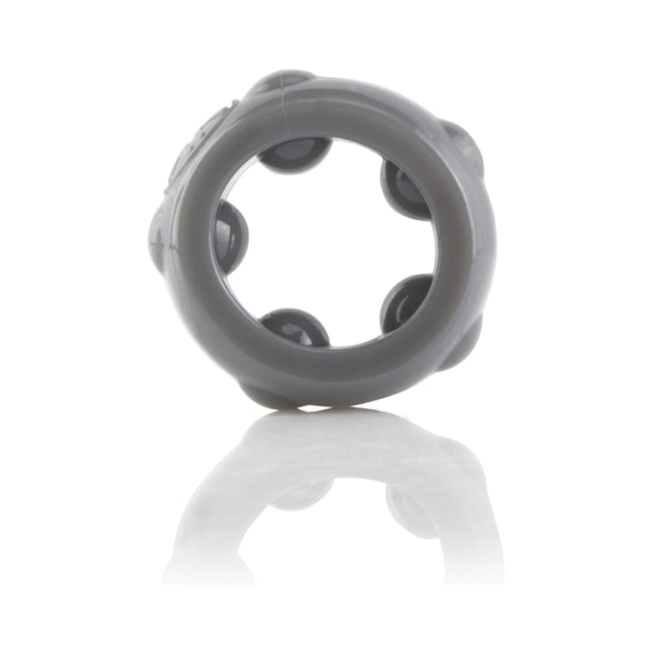 Black stretchy silicone erection ring with raised textured nodes, shown on reflective surface.