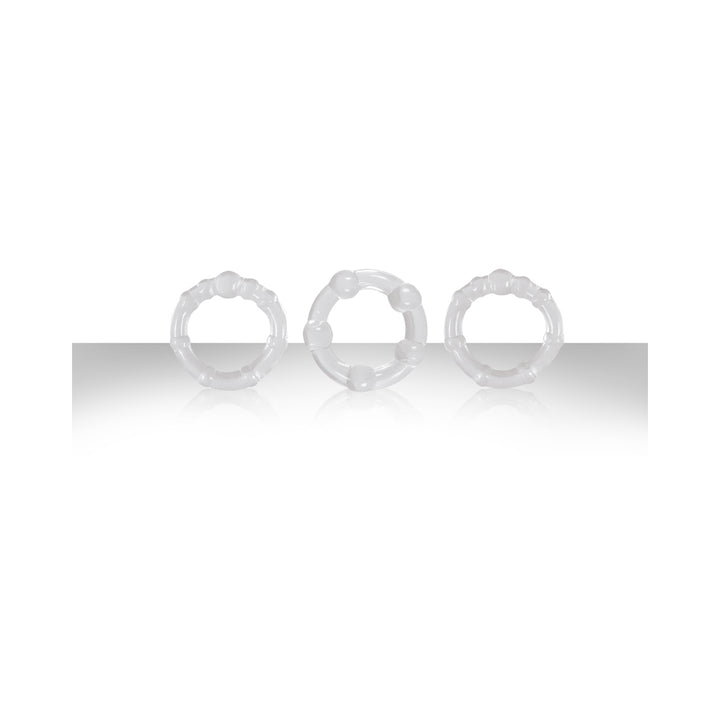 Three clear textured intensity rings made of stretchy material displayed on a reflective surface.