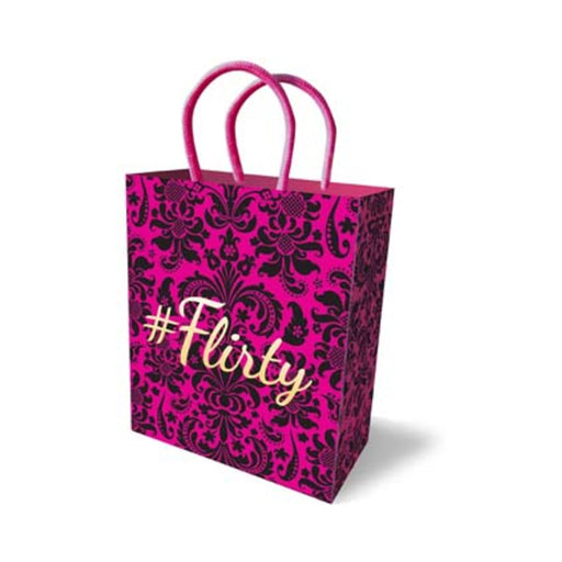 Pink gift bag with black floral pattern and #Flirty text, featuring pink rope handles