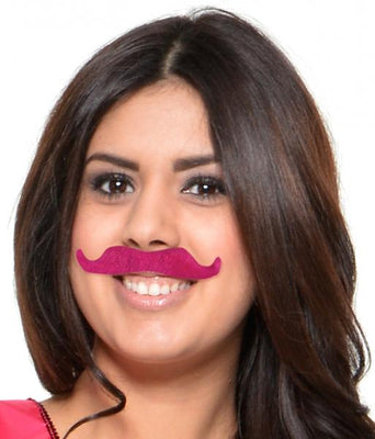 Woman wearing a bright pink adhesive party mustache from a 6-count mustache party favor kit.
