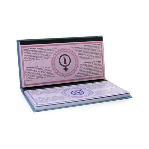Open booklet of A Year of Kama Sutra tip cards showing detailed instructions with gender symbols on each page.