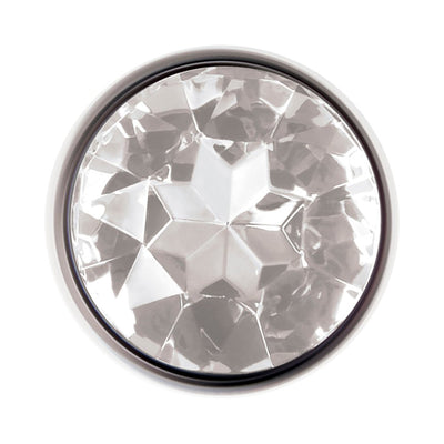 Top view of a polished aluminum anal plug featuring a clear faceted gem at the base.