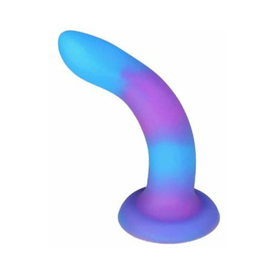 Curved purple and blue glow-in-the-dark silicone toy with suction base for versatile use.