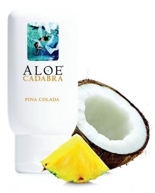 Aloe Cadabra 2.5oz Pina Colada personal moisturizer bottle with pineapple slice and halved coconut.