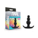 Black beaded silicone anal plug with three graduated beads and a flared base next to its colorful packaging box.