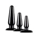 Set of three black tapered anal plugs in graduated sizes with flared bases for safe and comfortable use.
