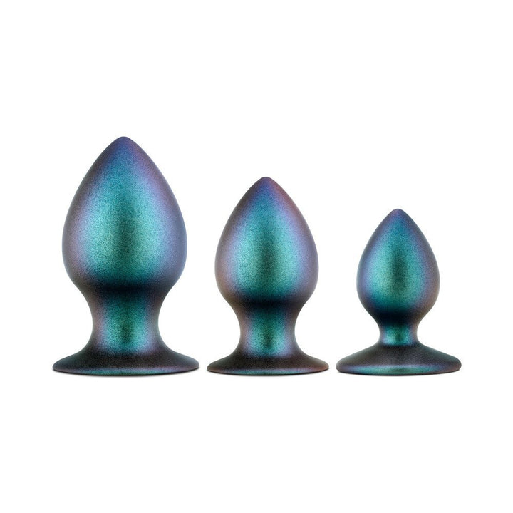Three iridescent metal anal plugs in small, medium, and large sizes with tapered tips and flared bases.