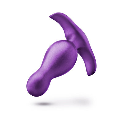Purple curved anal plug with ergonomic shape and flared base for secure, comfortable wear.