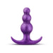 Purple anal plug with a graduated bead design and curved flared base for secure, comfortable wear.