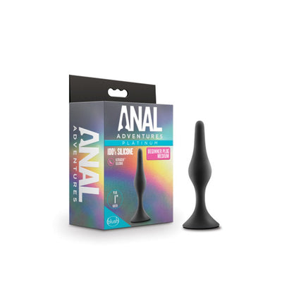 Medium black silicone beginner plug with tapered tip and flared base next to colorful Anal Adventures Platinum packaging.