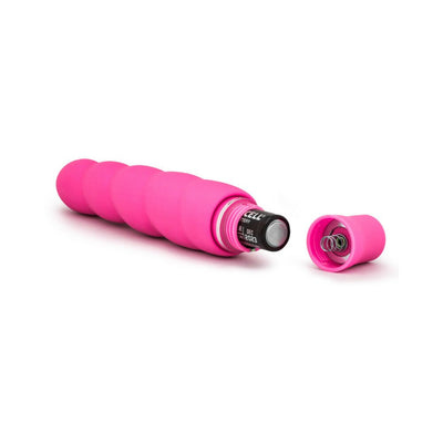 Pink spiral silicone vibrator with battery compartment open, showing inserted AA battery and cap removed.