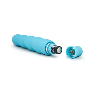Light blue silicone vibrator with spiral design, shown with battery inserted and cap removed on white background.