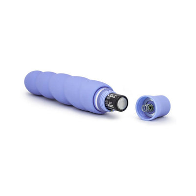 Lavender spiral silicone vibrator with removable cap showing inserted AA battery and spring mechanism.