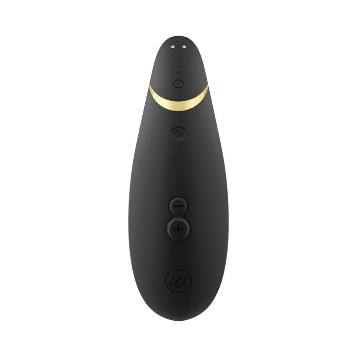 Black ergonomic clitoral stimulator with gold accent and multiple control buttons on a white background.