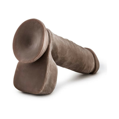 Brown dual-density flexible dildo with realistic texture and suction base on a white background.