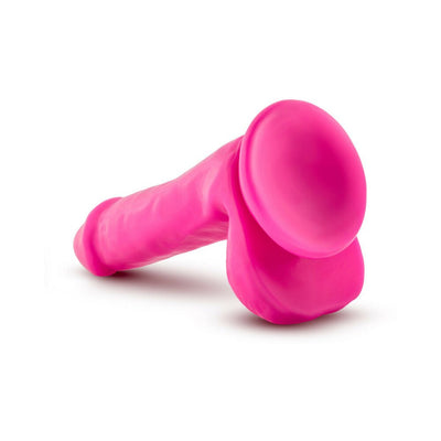 Pink realistic dildo with suction cup base and textured shaft, designed for comfort and versatility.