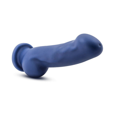 Ergonomically shaped indigo silicone dildo with realistic texture and suction base on white background.