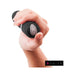Hand holding a black B Swish Bdesired Deluxe Curve personal massager with control buttons visible on the base.