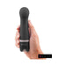 Hand holding a sleek black B Swish Bdesired Deluxe Curve personal massager with rounded tip and smooth silicone finish.