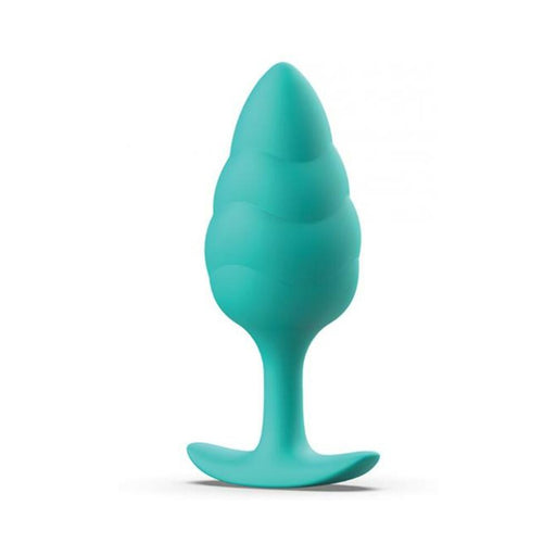 Seafoam green silicone plug with a tapered tip and wavy textured body on a flared base for safe use.