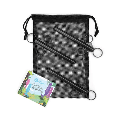 Three black lubricant applicators with finger rings displayed on a black mesh drawstring bag alongside a colorful B-Vibe Guide to Anal Play booklet.