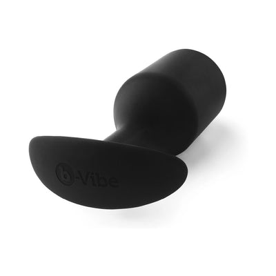 Black B-Vibe Snug Plug 7 made of smooth silicone with a tapered base and ergonomic handle for comfortable use.
