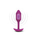 Medium-sized purple silicone vibrating plug with tapered tip and curved base, shown with vibration effect rings.