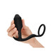 Hand holding a black weighted silicone plug with an attached flexible penis ring designed for dual stimulation.