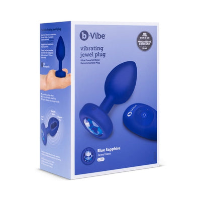 B-Vibe Vibrating Jewel Plug L/XL in blue sapphire with remote control and jewel base shown on packaging box.